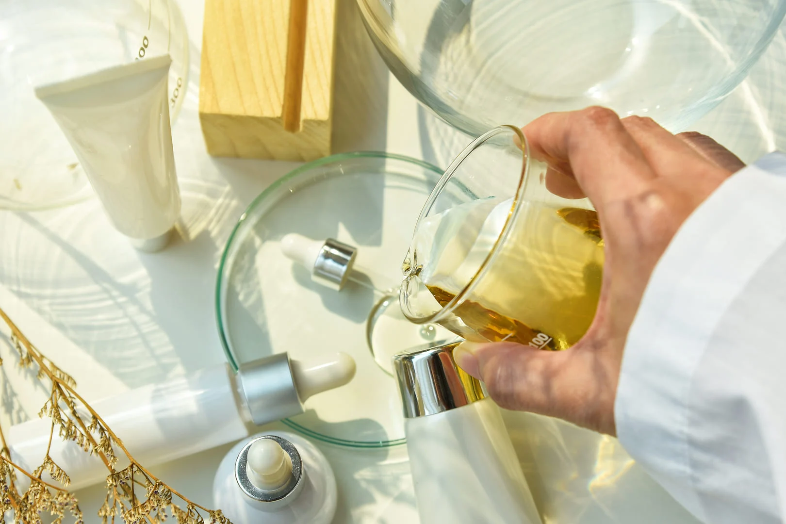 Scientist mixing OEM skincare product formulas in a laboratory, representing Malaysia's custom skincare production expertise.